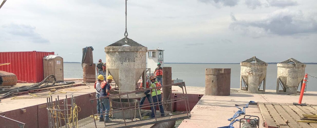 workers guiding crane lifting equipment SH 334 Bridge